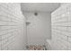 Stand up shower features a subway tile and stone floor and built in shelve at 4438 S Elati St, Englewood, CO 80110