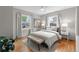 Bright bedroom with large windows, neutral décor, and hardwood floors at 4438 S Elati St, Englewood, CO 80110
