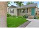Landscaped front yard of a cozy home, showcasing lush greenery and a welcoming entrance at 4438 S Elati St, Englewood, CO 80110