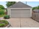 Two car detached garage with a driveway and landscaping at 4438 S Elati St, Englewood, CO 80110