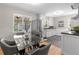 Bright kitchen featuring stainless steel appliances, a modern dining area, and stylish finishes at 4438 S Elati St, Englewood, CO 80110