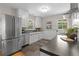Bright kitchen with stainless steel refrigerator, white cabinets, and stylish countertops at 4438 S Elati St, Englewood, CO 80110