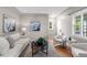 Bright living room features modern decor, hardwood floors and comfortable seating at 4438 S Elati St, Englewood, CO 80110
