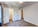 Well-lit bedroom with carpet, dual closets, and neutral walls at 2432 Candleglow St, Castle Rock, CO 80109