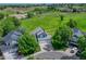Aerial view of a blue home with a well-manicured lawn and scenic surroundings at 901 Sage Sparrow Cir, Highlands Ranch, CO 80129
