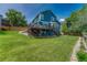 Well-maintained backyard showcasing a blue two-story home and spacious lawn at 901 Sage Sparrow Cir, Highlands Ranch, CO 80129