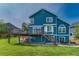 Exterior rear of a blue two-story home with a deck and patio area at 901 Sage Sparrow Cir, Highlands Ranch, CO 80129