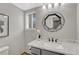 Well-lit bathroom features a granite countertop, modern mirror and window at 901 Sage Sparrow Cir, Highlands Ranch, CO 80129