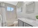Bright bathroom features a shower/tub combo, window and vanity with storage at 901 Sage Sparrow Cir, Highlands Ranch, CO 80129