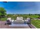 Outdoor deck featuring a modern seating area with a fire pit and scenic green views at 901 Sage Sparrow Cir, Highlands Ranch, CO 80129