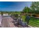 Outdoor deck overlooking green views, with seating and a potted plant at 901 Sage Sparrow Cir, Highlands Ranch, CO 80129
