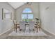 Elegant dining room with vaulted ceilings, modern chandelier, and a picturesque view at 901 Sage Sparrow Cir, Highlands Ranch, CO 80129