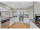Bright kitchen featuring white cabinets, granite countertops, stainless steel appliances and hardwood floors at 901 Sage Sparrow Cir, Highlands Ranch, CO 80129