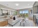 Open-concept living room with eat in kitchen, adjacent dining area and walk out balcony at 901 Sage Sparrow Cir, Highlands Ranch, CO 80129