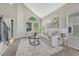 Bright living room featuring a neutral color palette, plush seating, vaulted ceilings and large windows at 901 Sage Sparrow Cir, Highlands Ranch, CO 80129