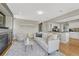 Cozy living room with a fireplace, area rug and view of kitchen area at 901 Sage Sparrow Cir, Highlands Ranch, CO 80129