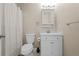 Bathroom featuring a toilet, tub-shower combo with white tiling, and a single sink vanity at 12142 Melody Dr # 301, Denver, CO 80234