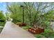 Community garden beds and walking path lined with green trees at 12142 Melody Dr # 301, Denver, CO 80234