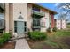 Two-story apartment building with balconies, updated entrance, and fresh landscaping at 12142 Melody Dr # 301, Denver, CO 80234