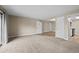 Large living room features fresh carpet, modern neutral paint, and an open floor plan at 12142 Melody Dr # 301, Denver, CO 80234