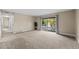 Spacious living room with large sliding glass door and neutral carpet perfect for relaxation at 12142 Melody Dr # 301, Denver, CO 80234