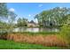 Pond with greenery and neighborhood homes in the background at 12142 Melody Dr # 301, Denver, CO 80234