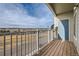 Balcony with wood flooring and a view of neighborhood streets and distant hills at 2705 S Danube Way # 306, Aurora, CO 80013