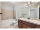 Bathroom featuring tile flooring, a tub with tiled walls, and a vanity with marble countertop at 2705 S Danube Way # 306, Aurora, CO 80013