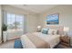 Comfortable bedroom featuring a large window, neutral decor, and a plush bed with decorative pillows at 2705 S Danube Way # 306, Aurora, CO 80013