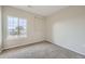 Bright bedroom featuring neutral walls, plush carpeting, and a window with neighborhood views at 2705 S Danube Way # 306, Aurora, CO 80013