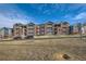 Apartment complex with brick and siding, with balconies and well-kept grounds at 2705 S Danube Way # 306, Aurora, CO 80013