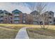 Apartment building exterior with multiple stories, brick facade, and manicured lawn at 2705 S Danube Way # 306, Aurora, CO 80013