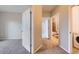 Hallway featuring plush carpeting leading to a bathroom, bedroom, and laundry room at 2705 S Danube Way # 306, Aurora, CO 80013