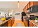 Well-equipped kitchen boasts modern appliances, rich wood cabinets, and sleek countertops at 2705 S Danube Way # 306, Aurora, CO 80013