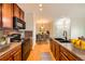 Updated kitchen featuring wood cabinets, stainless steel appliances, and a breakfast bar at 2705 S Danube Way # 306, Aurora, CO 80013