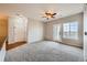 Bright living room featuring neutral walls, new carpet, and a door to the outside at 2705 S Danube Way # 306, Aurora, CO 80013