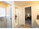 Shower with glass door, a bathroom sink and a view to the main bedroom at 1908 Homestead Dr, Fort Lupton, CO 80621