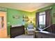 Bedroom features mountain murals, natural light, and neutral furniture at 1908 Homestead Dr, Fort Lupton, CO 80621