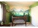 Charming Bedroom featuring a crib, mountain mural, and window with natural light at 1908 Homestead Dr, Fort Lupton, CO 80621