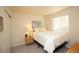 Cozy bedroom features a comfortable bed, bedside table, and a bright window at 1908 Homestead Dr, Fort Lupton, CO 80621