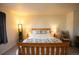 Relaxing bedroom featuring a queen-size bed, soft lighting, and decorative pillows at 1908 Homestead Dr, Fort Lupton, CO 80621