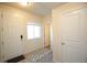 Bright foyer with white walls, tile entry, large front door, and access to other rooms at 1908 Homestead Dr, Fort Lupton, CO 80621