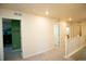 Bright hallway featuring doorways and white railings offering clear and open passage at 1908 Homestead Dr, Fort Lupton, CO 80621
