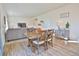 Open living area features a dining table and chairs, leading into the adjacent living room with plush sofa at 1908 Homestead Dr, Fort Lupton, CO 80621