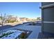 Street view showcasing a quiet neighborhood with well-maintained homes, sidewalks, and some snow at 1908 Homestead Dr, Fort Lupton, CO 80621