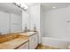 Bright bathroom with large vanity, tile floor, and soaking tub is an ideal place to relax at 2958 Syracuse St # 316, Denver, CO 80238