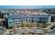 Modern condo building featuring a sleek design, balcony, and well-maintained landscaping at 2958 Syracuse St # 316, Denver, CO 80238