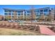 Modern condo building with sleek architecture, large windows, and well-maintained landscaping at 2958 Syracuse St # 316, Denver, CO 80238