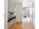 A view of a bedroom and living room with hardwood floors and natural light from large windows at 2958 Syracuse St # 316, Denver, CO 80238