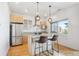 Modern kitchen with stainless steel appliances, granite countertops, and stylish barstool seating at 2958 Syracuse St # 316, Denver, CO 80238